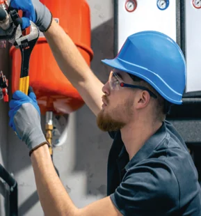 Engineer working on mechanical pipework